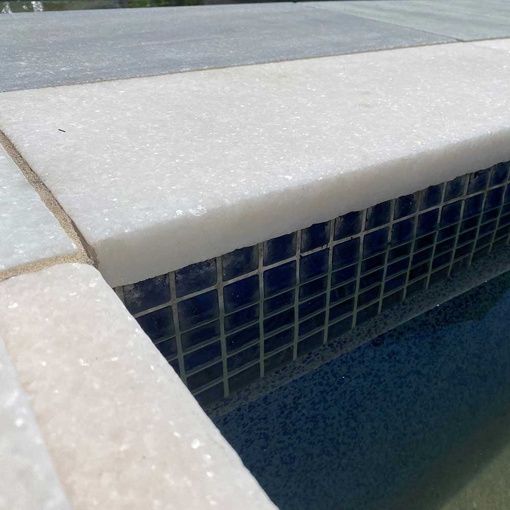 Cristallo Bianco Tumbled Marble 600x400x30/60 Drop Nose Coping - 1st Quality - Laid around pool - Available at Simon's Seconds